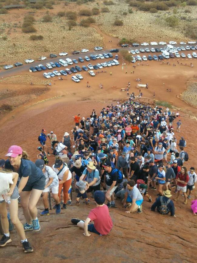 Crowds attempting to climb Uluru.