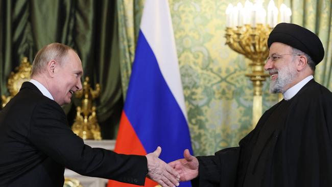 Vladimir Putin (L) shakes hands with Iran's President Ebrahim Raisi during their meeting in the Kremlin recently. Picture: AFP.