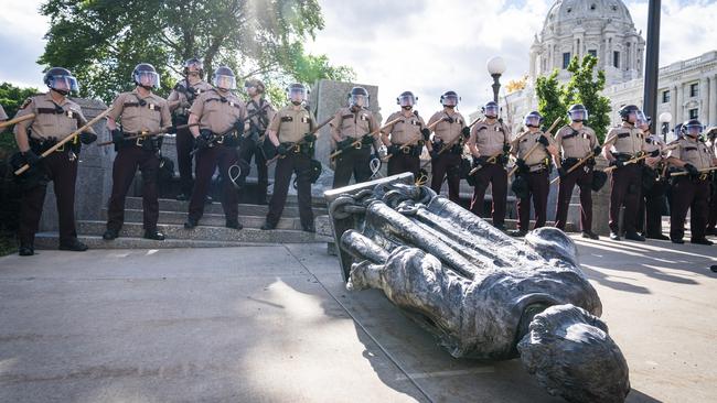 Minnesota State Troopers surrounded the statue of Christopher Columbus after activists pulled it down in 2020. Picture: Star Tribune/Getty Images