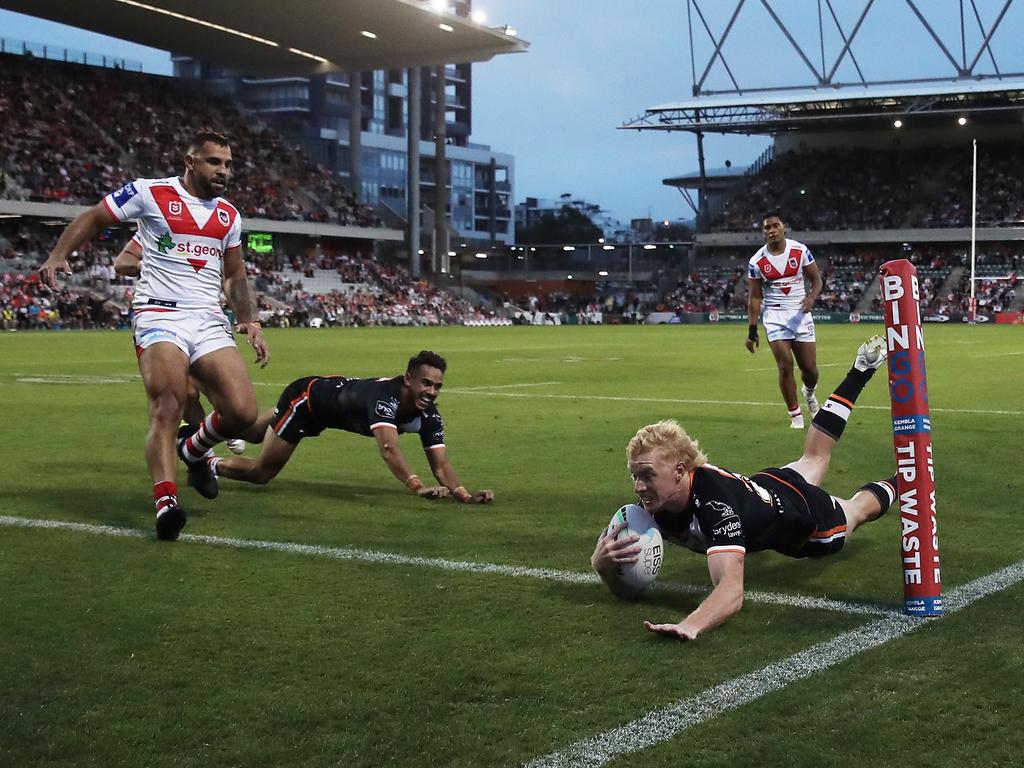 Zac Cini of the Tigers scores a try.