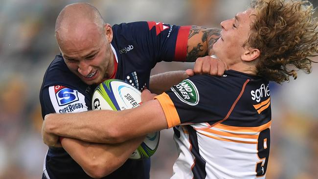 Billy Meakes of the Rebels barrels through Joe Powell during Melbourne’s loss to the Brumbies. Picture: AAP