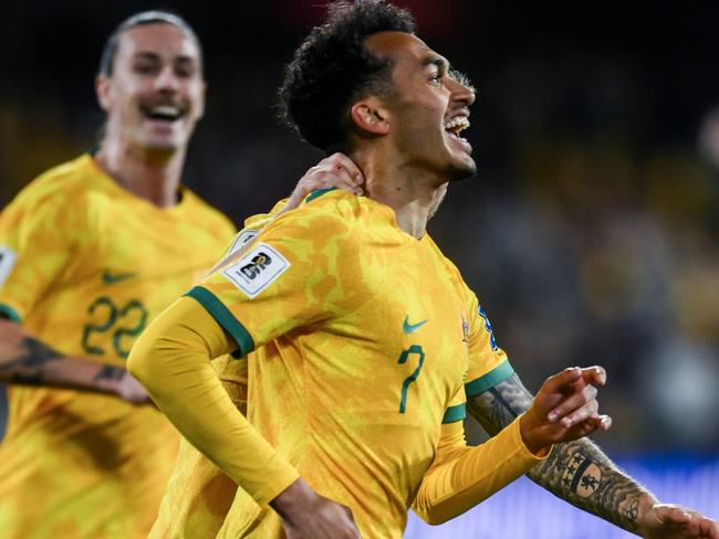 ADELAIDE, AUSTRALIA - OCTOBER 10: Nishan Velupillay of the Socceroos  celebrates after scoring his teams third  goal with  Riley McGree of the Socceroos   during the third round FIFA World Cup 2026 Qualifier match between Australia Socceroos and China PR at Adelaide Oval on October 10, 2024 in Adelaide, Australia. (Photo by Mark Brake/Getty Images)