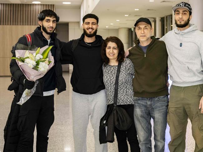 A family is reunited at Sydney Airport after the Qantas flight arrives. Picture: NCA NewsWIRE / Monique Harmer