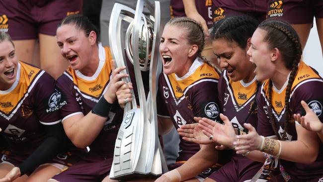 Ali Brigginshaw leads her team in the song as she holds the trophy. Picture: Mark Metcalfe/Getty Images