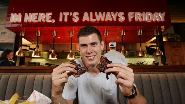 Collingwood player Mason Cox at the new TGI Friday restaurant at Chadstone last year. Picture Andrew Tauber