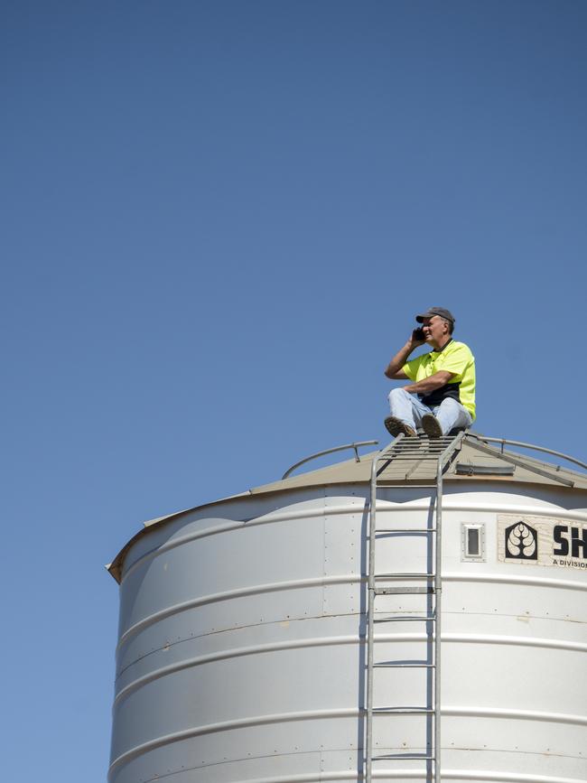 Geoff Kendell tries to get mobile phone coverage on top of a silo on his farm at Kerang. Picture: Dannika Bonser