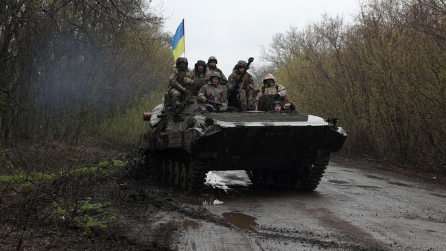 Ukrainian soldiers stand on an armoured personnel carrier in Izyum district, Kharkiv region. Macquarie Bank’s Viktor Shvets says the house view, consistent since the invasion, has been that there is no basis for compromise. Picture: AFP