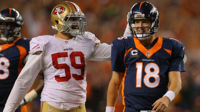 Linebacker Aaron Lynch congratulates quarterback Peyton Manning.