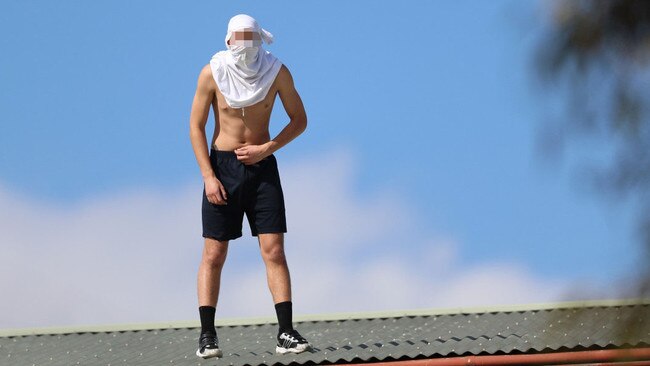 A Youth on roof of the Parkville Detention Centre. Picture: Alex Coppel