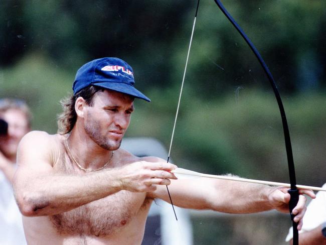 Adelaide Crows footballer Scott Hodges with bow and arrow during archery at 'Camp Torture' training session at Rapid Bay in the pre-season of 1993. Picture: FILE