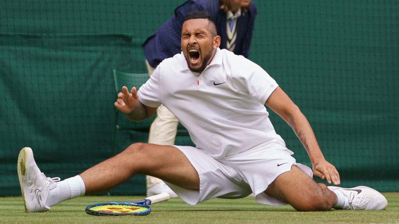 TOPSHOT - Australia's Nick Kyrgios slips while playing France's Ugo Humbert during their men's singles first round match on the third day of the 2021 Wimbledon Championships at The All England Tennis Club in Wimbledon, southwest London, on June 30, 2021. (Photo by AELTC/Jon Super / POOL / AFP) / RESTRICTED TO EDITORIAL USE