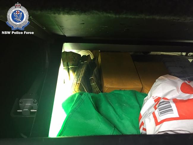 The secret compartment in the floor of the Rav 4 containing 1kg of cocaine, 4kg of MDMA and $101,000 cash. Picture: NSW Police