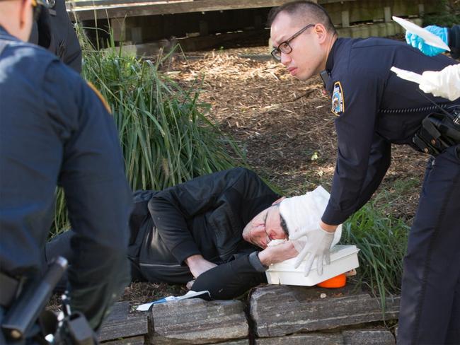 Authorities attend to an injured man after a vehicle attack in New York. Picture: William Farrington, New York Post