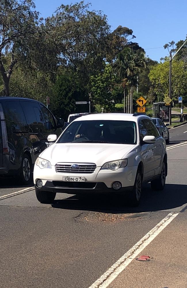 A car about to hit a pothole on Wakehurst Parkway at Seaforth on Thursday. Picture: Jim O'Rourke