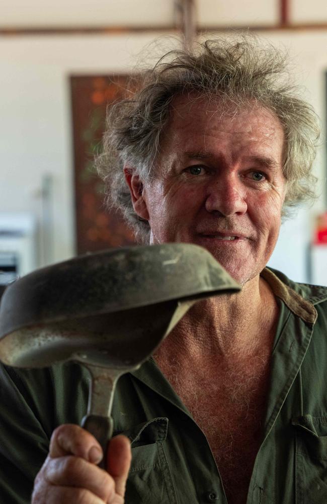 Trevor Sullivan holds up a cast iron pan Big Jack destroyed as a young croc. Picture: Pema Tamang Pakhrin