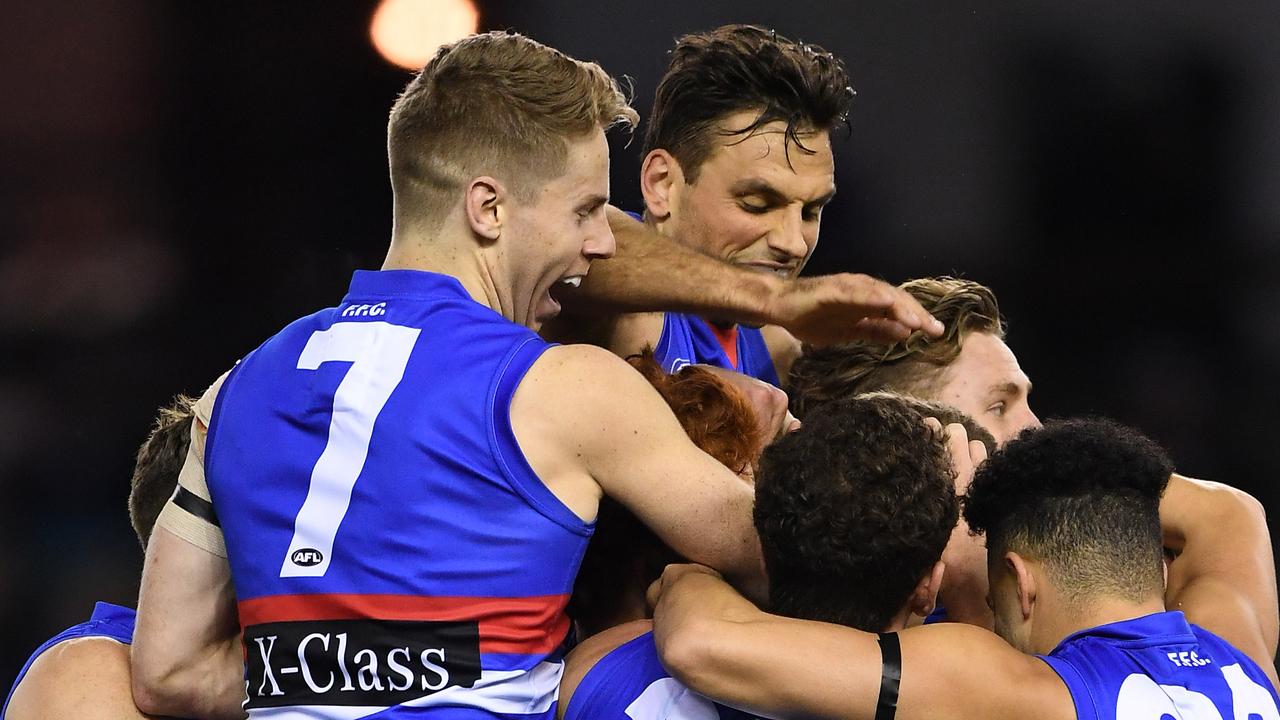 Bulldogs players celebrate Rhylee West’s first AFL goal.