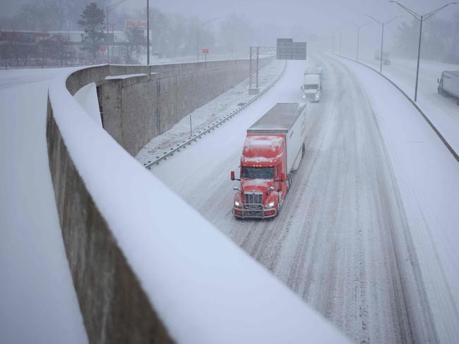 Semi trucks drive through the snow along I-264 on January 5, 2025 in Louisville, Kentucky. Local forecasts called for heavy snowfall followed by significant accumulation of freezing rain and ice. Picture: AFP