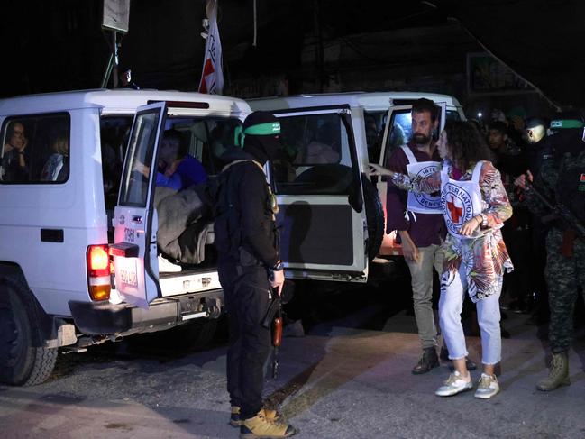 Members of the Red Cross prepare to transport hostages released by Hamas in Rafah, in the southern Gaza Strip. Picture: AFP