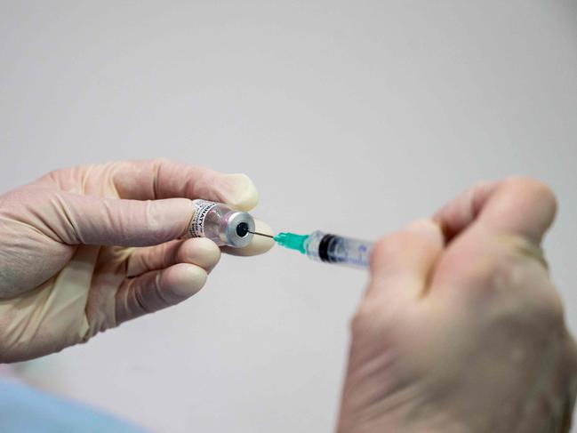 A nurse fills a syringe with the Pfizer Biontech vaccine Comirnaty at the vaccination center of German speciality chemicals company Evonik in Hanau, western Germany, on Mai 19, 2021, amid the ongoing coronavirus (Covid-19) pandemic. (Photo by THOMAS LOHNES / AFP)