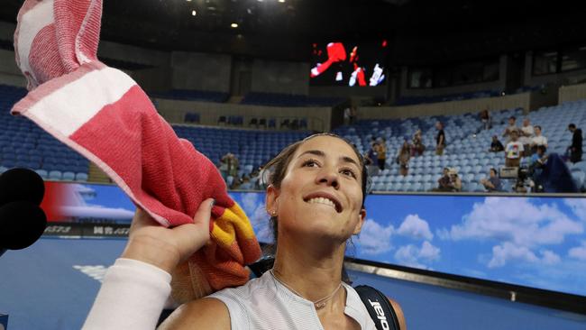 Spain's Garbine Muguruza throws her towel into the crowd as she celebrates after defeating Britain's Johanna Konta in their second round match at the Australian Open tennis championships in Melbourne, Australia, Friday, Jan. 18, 2019. (AP Photo/Mark Baker)