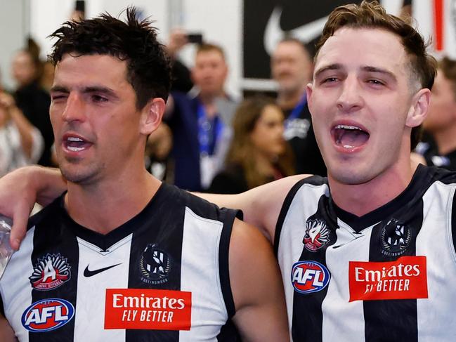 MELBOURNE, AUSTRALIA - APRIL 25: Scott Pendlebury, Trey Ruscoe and Oleg Markov of the Magpies sing the team song during the 2023 AFL Round 06 match between the Collingwood Magpies and the Essendon Bombers at the Melbourne Cricket Ground on April 25, 2023 in Melbourne, Australia. (Photo by Dylan Burns/AFL Photos via Getty Images)