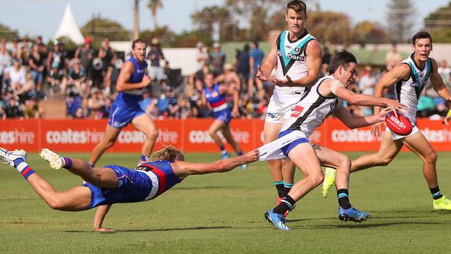 WHYALLA, AUSTRALIA - MARCH 07: Zak Butters of the Power is tackled by Bailey Smith of the Bulldogs during the 2020 Marsh Community Series match between the Port Adelaide Power and the Western Bulldogs at Bennett Oval on March 07, 2020 in Whyalla, Australia. (Photo by Matt Turner/AFL Photos via Getty Images)