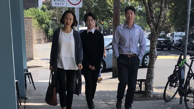 Seunghwan Byun (centre) pictured outside court with his parents.