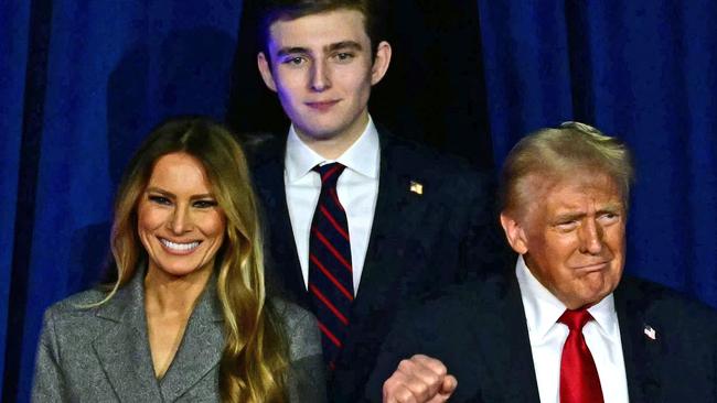 TOPSHOT - Former US President and Republican presidential candidate Donald Trump (R) arrives for  an election night event alongside former US First Lady Melania Trump and his son Barron Trump at the West Palm Beach Convention Center in West Palm Beach, Florida, on November 6, 2024. (Photo by Jim WATSON / AFP)