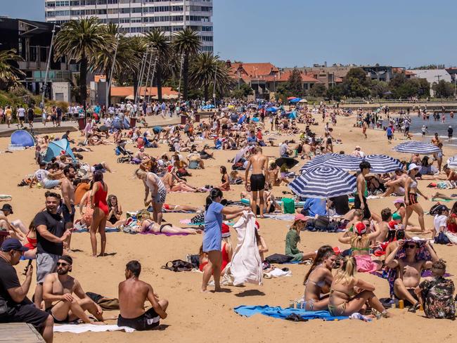 People celebrate Christmas at St Kilda Beach. Picture: Jason Edwards