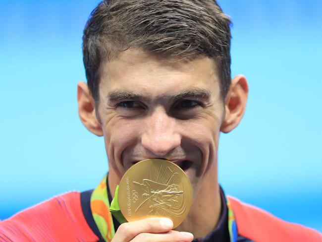 Michael Phelps celebrates with his 23rd Olympic gold medal after helping the US win the 4x100m medley relay. Picture: Alex Coppel