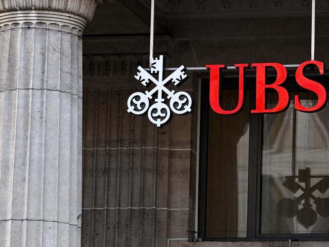 A sign and logo of the Swiss giant banking UBS is seen in Lausanne on February 6, 2024. Swiss banking giant UBS said on February 6, 2024 it would hand shareholders up to 1 billion US dollars in share buybacks as it posted a smaller-than-expected quarterly loss stemming from the costs of absorbing fallen rival Credit Suisse. (Photo by Fabrice COFFRINI / AFP)