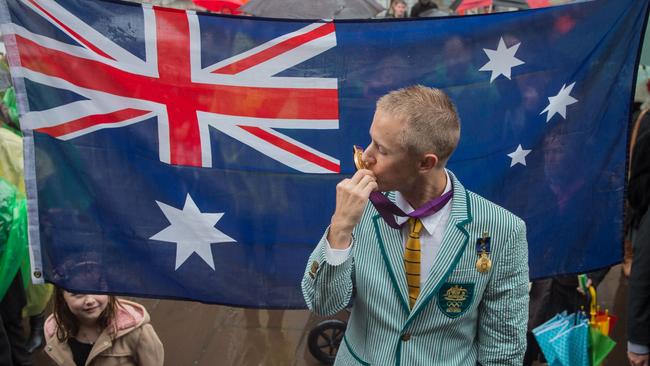 Australian athlete Jared Tallent poses for a photo after he was presented with his 2012 Olympics gold medal