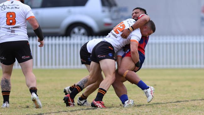 Campbelltown Collegians winger Kolin Saukuru is hit hard by The Oaks Tigers defenders led by Cooper Smith. Picture: Steve Montgomery