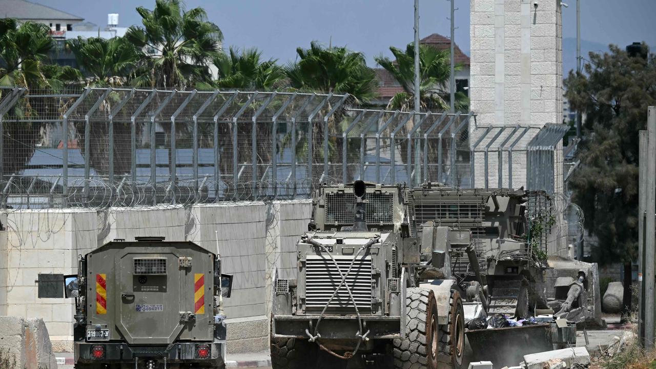 Israeli armoured vehicles including a bulldozer drive in a street during an army raid in Jenin in the occupied-West Bank on August 31. Picture: AFP