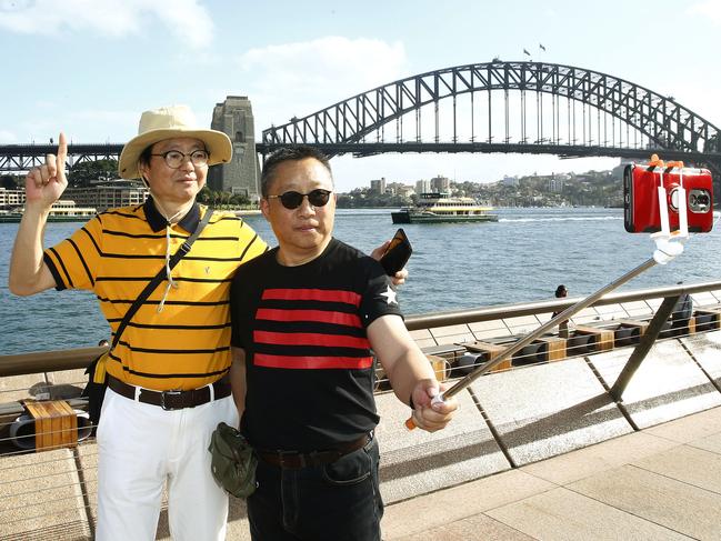 L to R: visitors from China, ppose for a Harbour Brisgde selfie while taking  in the sights around the Sydney Opera House. Sydney wants to attract more tourists from China. Picture: John Appleyard