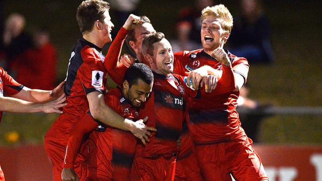 Redlands players swarm Paul O'Brien after he netted the match winner.