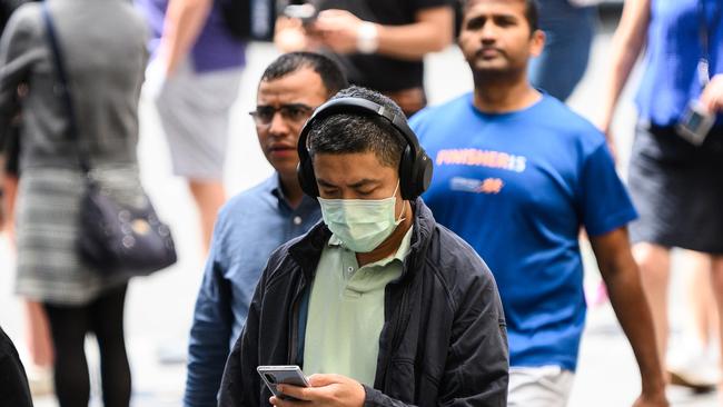 People being cautious wearing masks. (AAP Image/James Gourley)