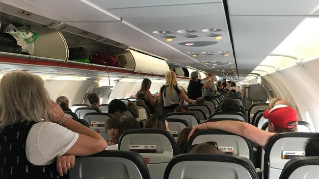 Photo from passenger on board Melbourne to Hobart Jetstar flight JQ713, which has been stuck on the tarmac at Hobart Airport for more than an hour and a half since landing as emergency services respond to an unwell passenger. Picture: SUPPLIED