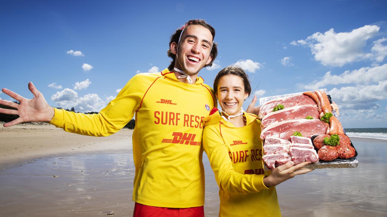 Dicky Beach Lifesavers Luke and Zara Morris with a meat tray from Pinnell's Gourmet Meats, the surf club took their legendary meat raffles online to keep functioning while in coronavirus lockdown. Picture: Lachie Millard