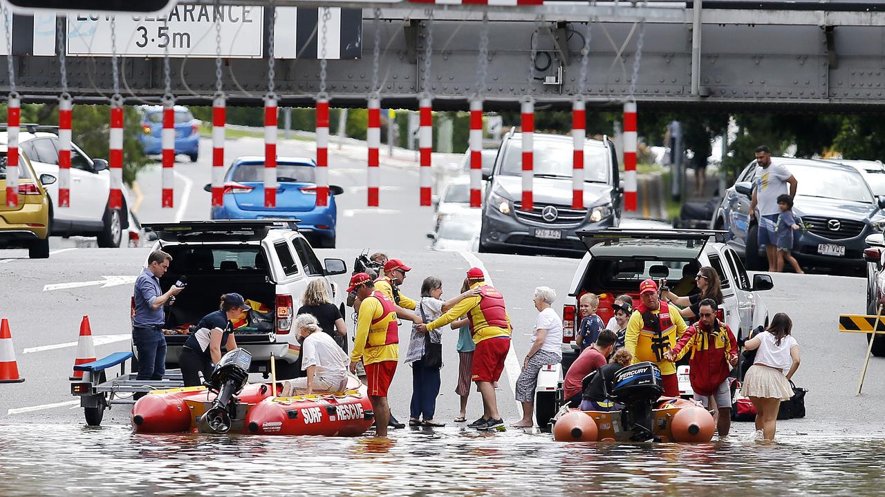 Lifesavers rescuing people from flood waters in Toowong in 2022. Insurance premiums have soared since then. Picture: Josh Woning