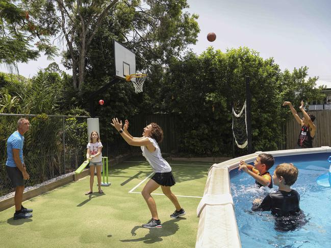 NWNAUSNEWSTwo years ago, Mark and Helene Clarkson decided enough was enough - they needed to get the kids outside. They gutted the backyard of their property in the inner-Brisbane suburb of Coorparoo and created the ultimate kid friendly space. Getting every last bit of space out of their 450sqm block, they placed astroturf around the pool created spaces for the kids to play soccer. The reno worked just as planned, becoming a hit with neighbours and school friends. At least two to four kids out the back every weekend, with the the adults often getting out there too.Pictured is Mark and Helene Clarkson with children Zak(16, black singlet) Harry (10, in the pool orange sleeves) also neighbours Sam Robba (10yrs in the pool, black wet shirt) and Maddy Robba (12yrs)Photography : Russell Shakespeare