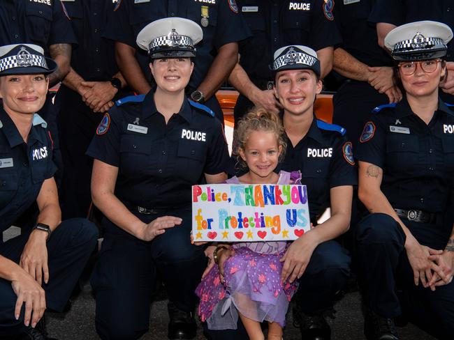 Savannah Shirvington with her thank you note as members of the NT Police, Australian Federal Police, Military Police and Colours and retired police officers marched through the Darwin CBD for National Police Remembrance Day. Picture: Pema Tamang Pakhrin