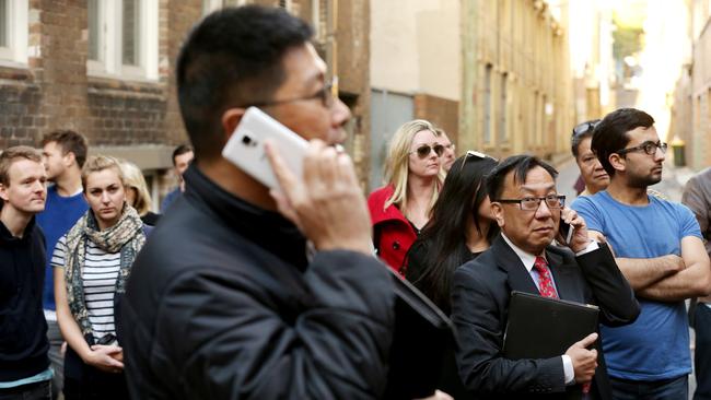 Sydney's narrowest house auction at 29 Terry St Surry Hills. The property sold for $965,000 to a Chinese phone bidder, ( tall asian man with Samsung phone & card 28, closest other bidder was man and woman card 8)  Pic Stephen Cooper