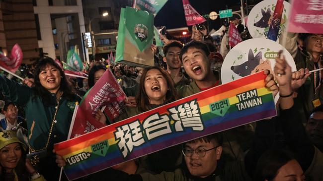 Democratic Progressive Party supporters celebrate the victory of William Lai outside the party's headquarters in Taipei on Saturday night. Picture: AFP