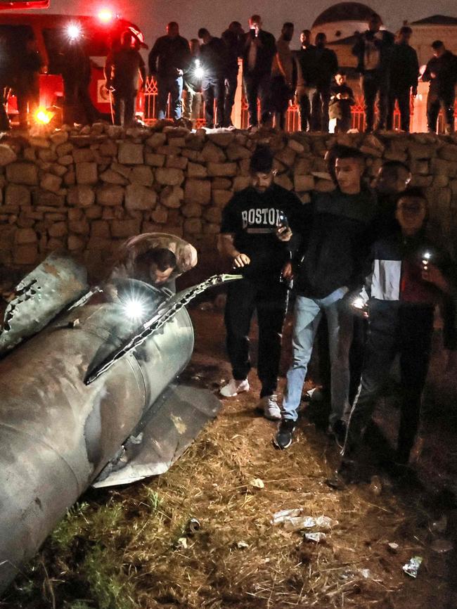 Palestinian youths inspect a fallen projectile in Ramallah in the occupied West Bank after Iran fired missiles at Israel. Pictture: Zain Jaafar/AFP