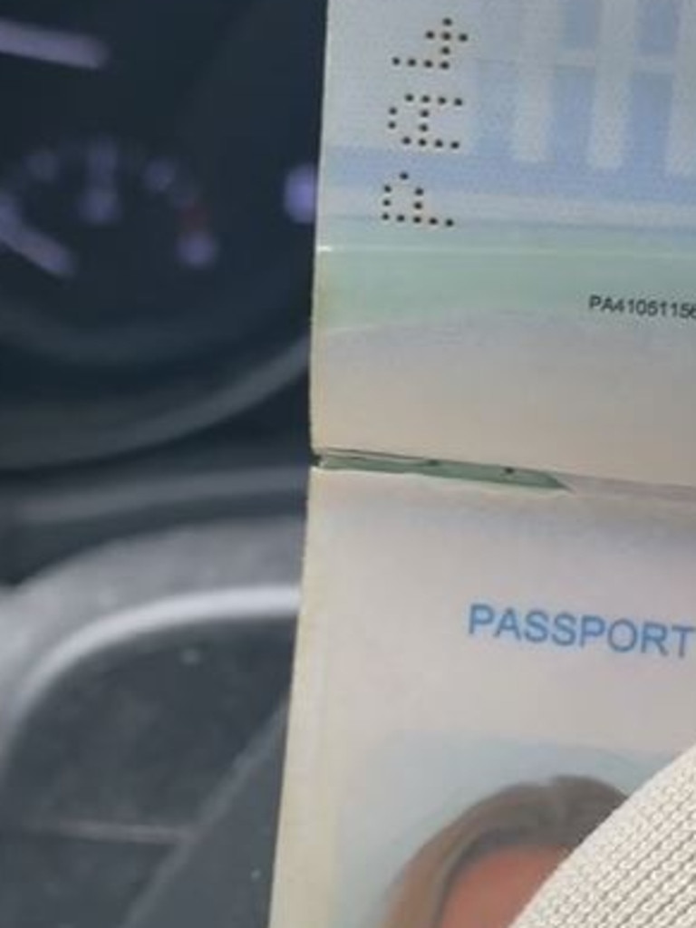 The tear looks like part of the passport’s spine, but it is actually a tear.