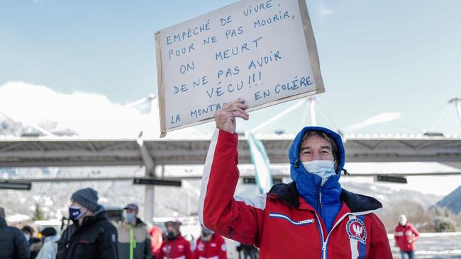 A protester holds a placard this week during a demonstration asking for the re-opening of the ski resort in the French Alps for the Christmas holidays. Picture: AFP