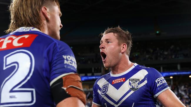 SYDNEY, AUSTRALIA - APRIL 02: Matt Burton of the Bulldogs celebrates with Jacob Preston of the Bulldogs after kicking the winning field goal in extra time during the round five NRL match between Canterbury Bulldogs and North Queensland Cowboys at Accor Stadium on April 02, 2023 in Sydney, Australia. (Photo by Cameron Spencer/Getty Images)