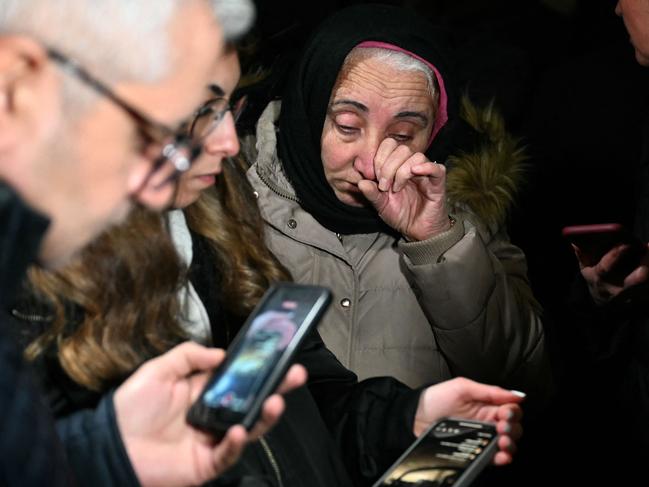 A woman reacts as relatives of hostages watch on their smartphone a live broadcast made by the assailant at Procter & Gamble in Kocaeli near Istanbul. Picture: AFP