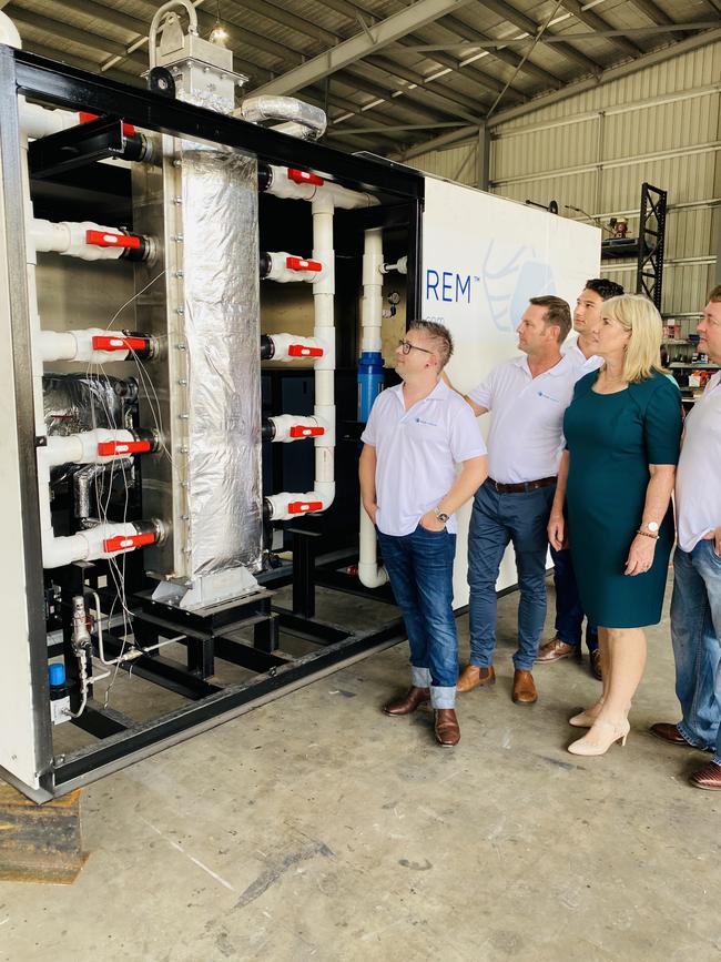 Darwin Hydrogen trial. Minister for Renewable Energy Eva lawler inspects Aqua Aerem's mini Hydrogen plant with its creators Jarrod Ward (left) Gerard Reiter (right) which will be trialled at Tennant Creek. PICTURE GARY SHIPWAY